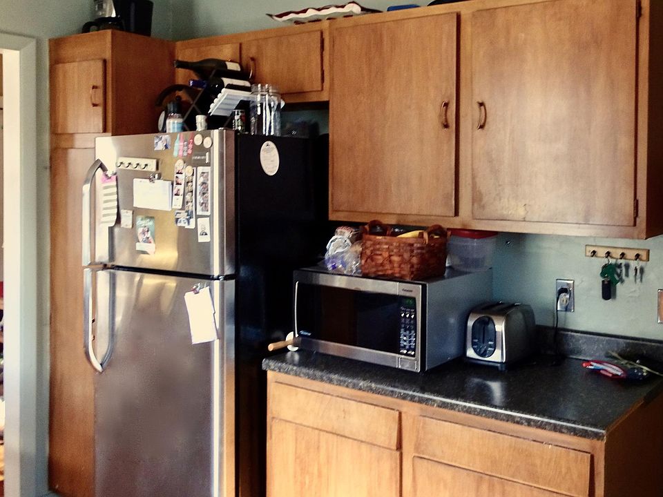 Many cabinets and stainless refrigerator.