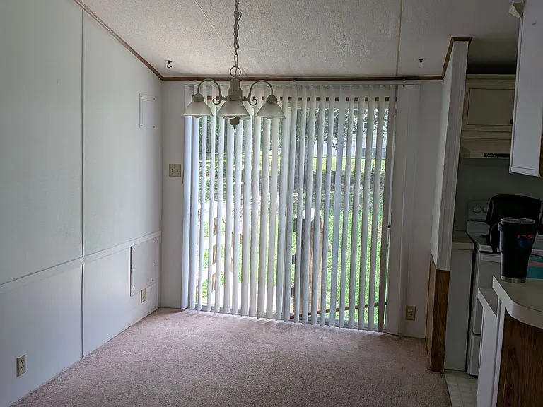 Dining room with sliding glass door leading to large back yard with shade tree and large shed