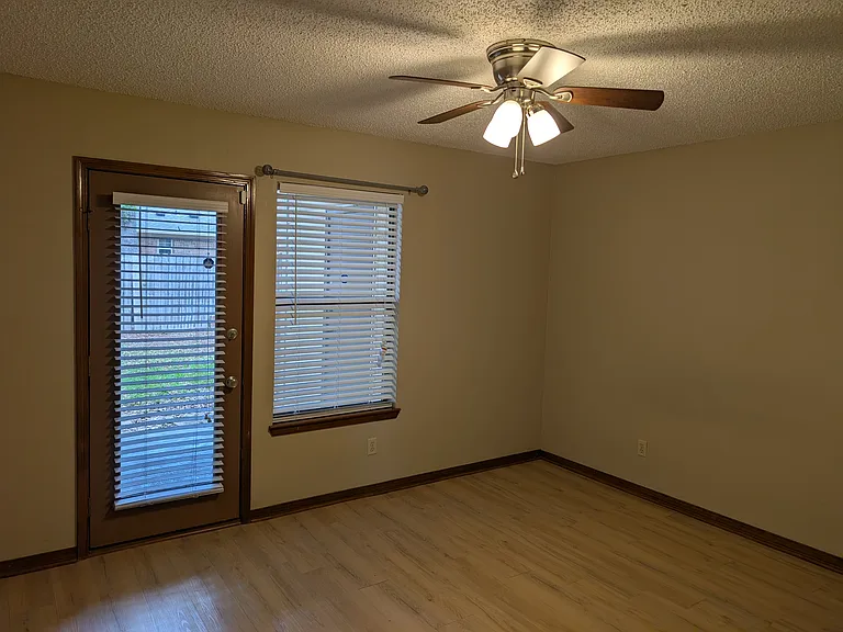 Master bedroom with access to back porch and additional storage