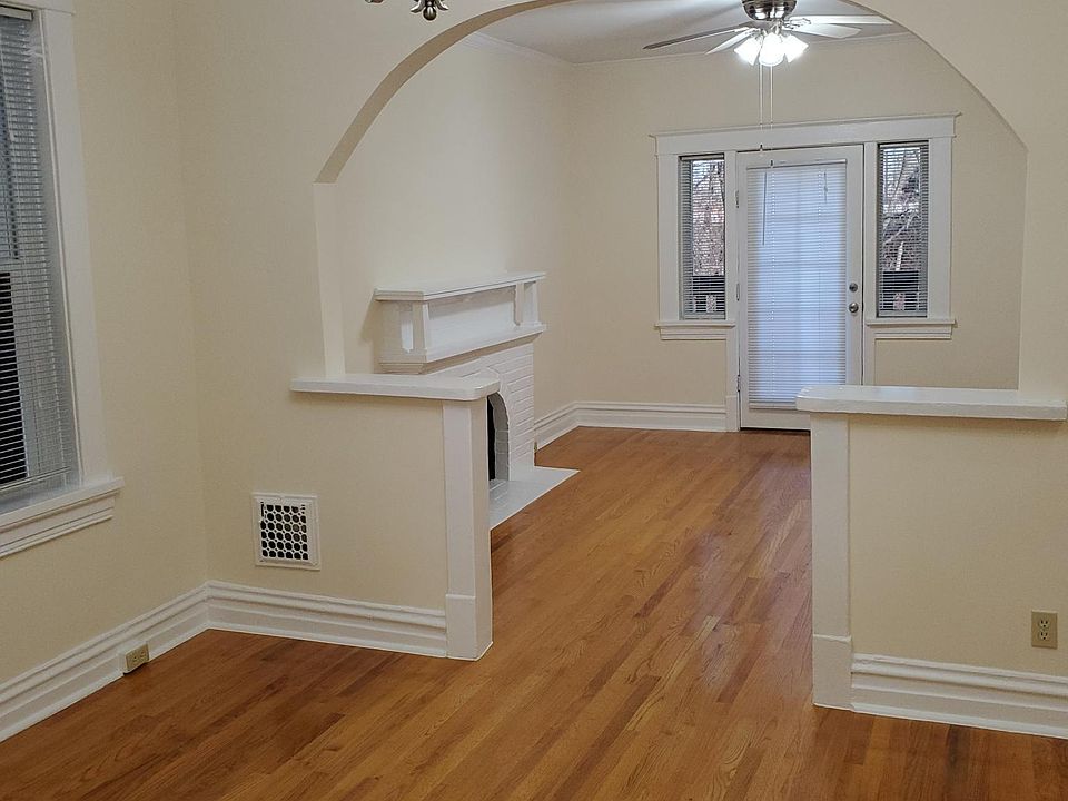 View of the front 2 rooms with Chandelier in the middle and Ceiling Fan in the Front