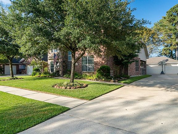 Long drive leads to the 3 car garage located in a Klein ISD community.