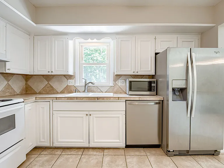 Kitchen appliances are all included featuring mostly stainless (fridge/freezer, dishwasher, and microwave) appliances