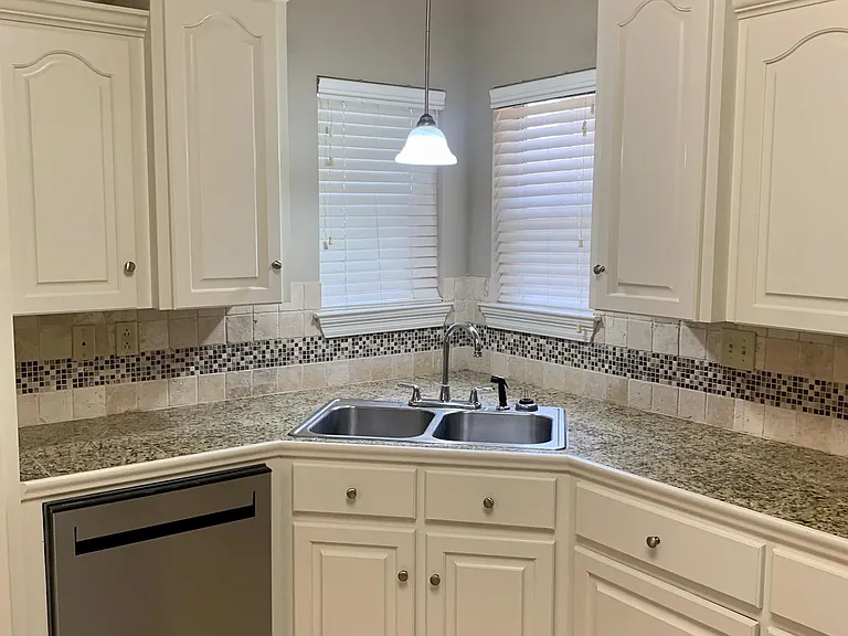 matching backsplash with granite tile top. All cabinets have been freshly painted