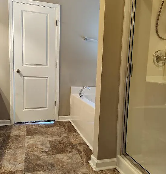 The primary bedroom and attached bathroom is located on the main floor.