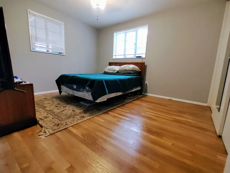 Original Hardwood Floors and 3 speed overhead fan, with a large closet in the Master Bedroom!