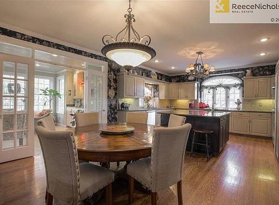 Open eat-in kitchen connects to hearth room and light-filled sunroom