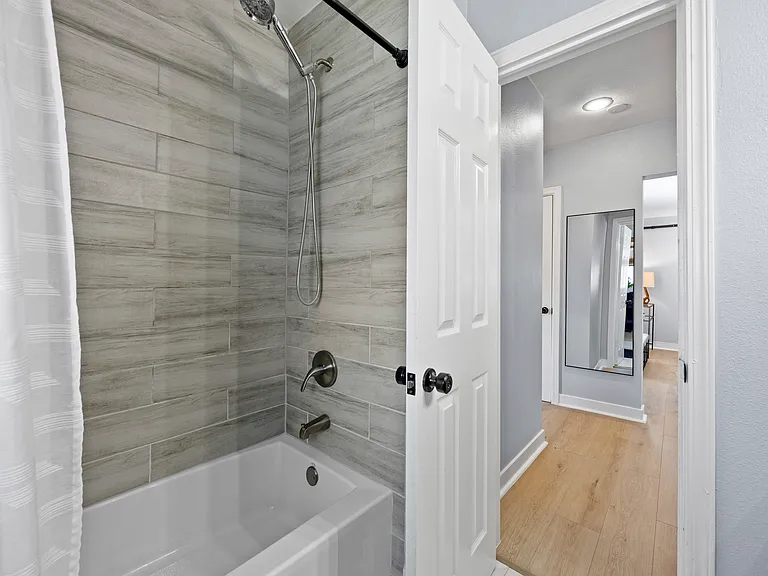Newly renovated bathroom with full tub + shower.