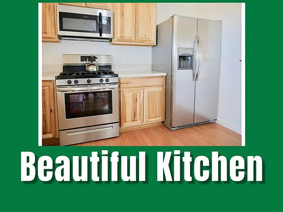 The kitchen is a beautifully designed space featuring modern appliances, wood cabinetry, and ample counter space. This functional and stylish area is perfect for preparing meals and entertaining guests.
