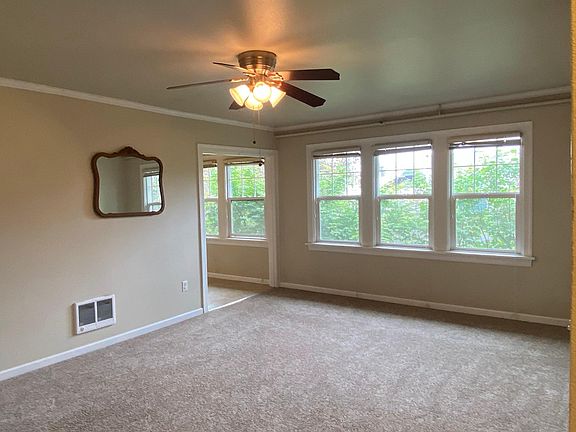 Living room windows provide lots of light and overlook trees.
