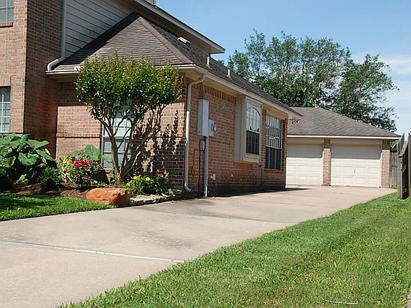 The long driveway leads to a huge three-car garage.