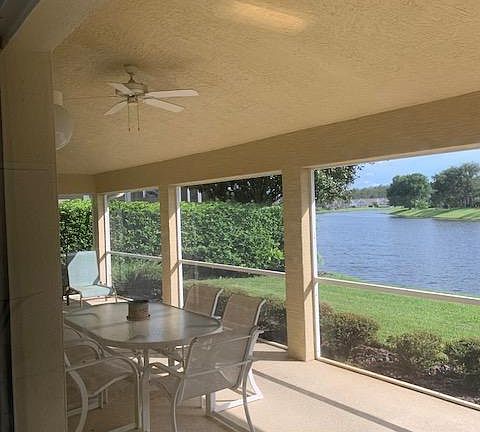 BACK LANII VIEW, SCREENED PORCH WITH FAN.