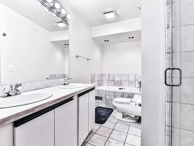 Primary en-suite bathroom with whirlpool and marble shower