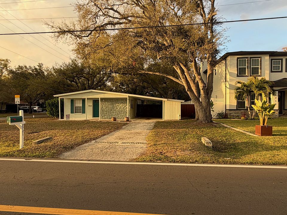 Front view of 2721 Ballast Point Blvd. Utility shed to right of carport. Washer and dryer with small storage area.