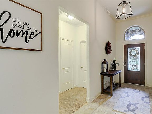 As you enter this 3 car garage, 4 bedroom home, you are greeted by a gracious entry with updated lantern fixtures.