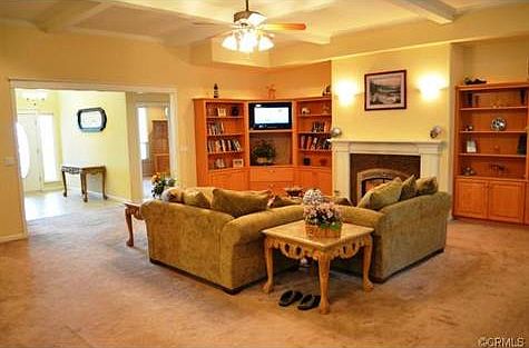 The living room has great built-ins and gorgeous boxed beam ceil