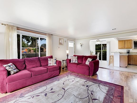 Living room with hardwood floors, lots of natural light with south and west facing windows