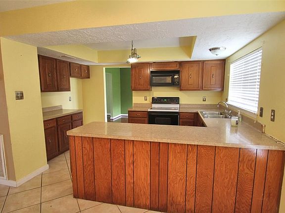 good sized kitchen with electric range, microwave and dishwasher