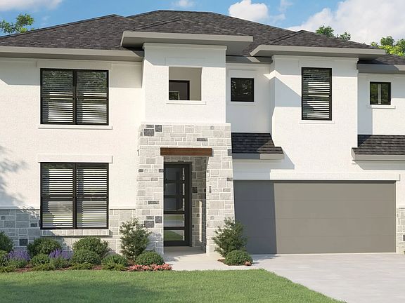 Sleek stonework and expansive windows enhance this modern Magnolia home at Lakeside Meadows.