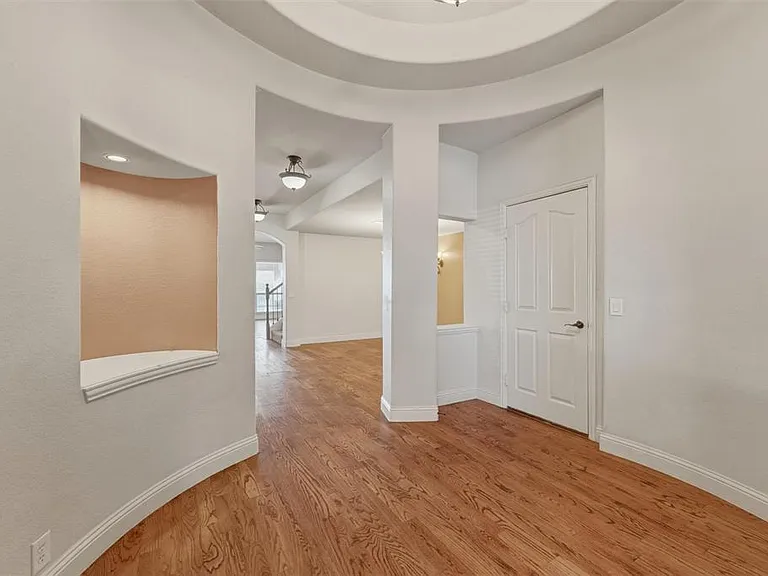 Foyer with hard wood flooring.