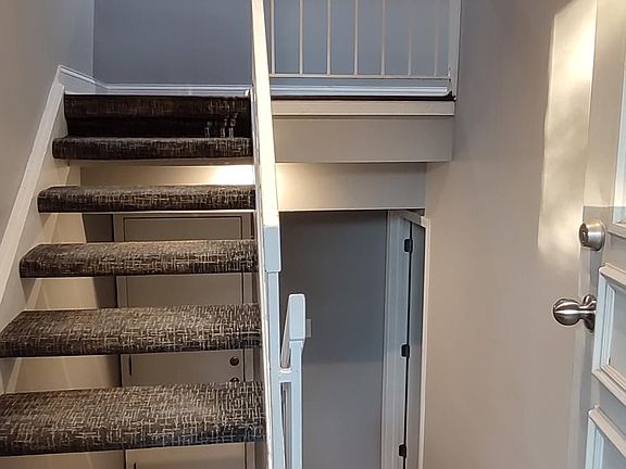 front door view , with stair case going to the upper level and stair case to the lower level ( 3rd bedroom. laundry room and garage)