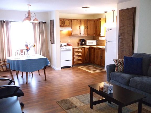 The living/kitchen/dining area is uncluttered and comfortable. (The kitchen cabinets have been painted since this picture was taken.)