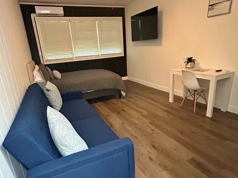 Bright and inviting studio with elegant blinds and natural light.