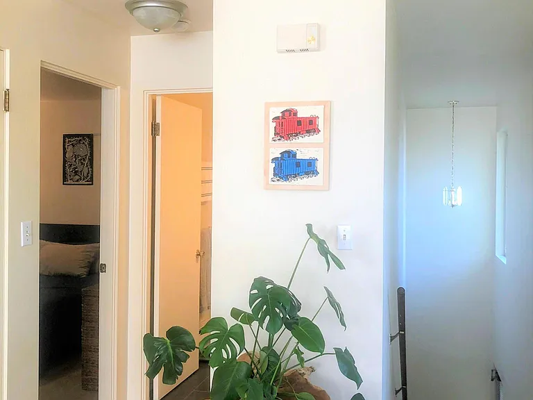 Stairs to main entry on right, Bedroom door on left, Bathroom door in middle