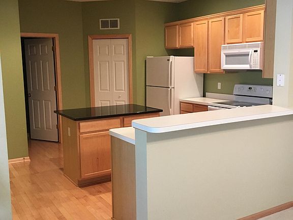 Kitchen with large island.  Refrigerator, oven, microwave an