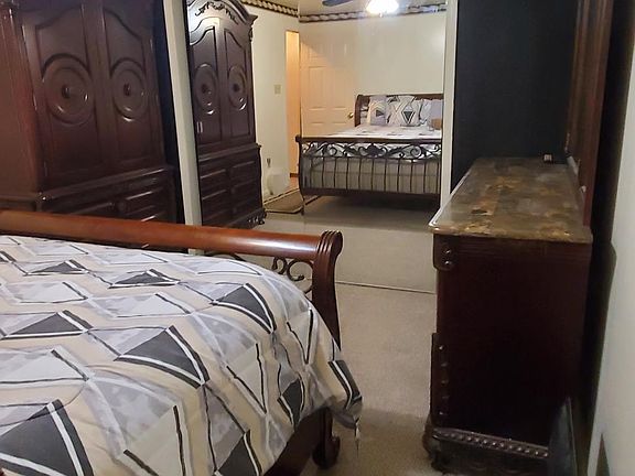 Large bedtoom with Queen Slay Bed with granite counter top dresser, night stand and Chest