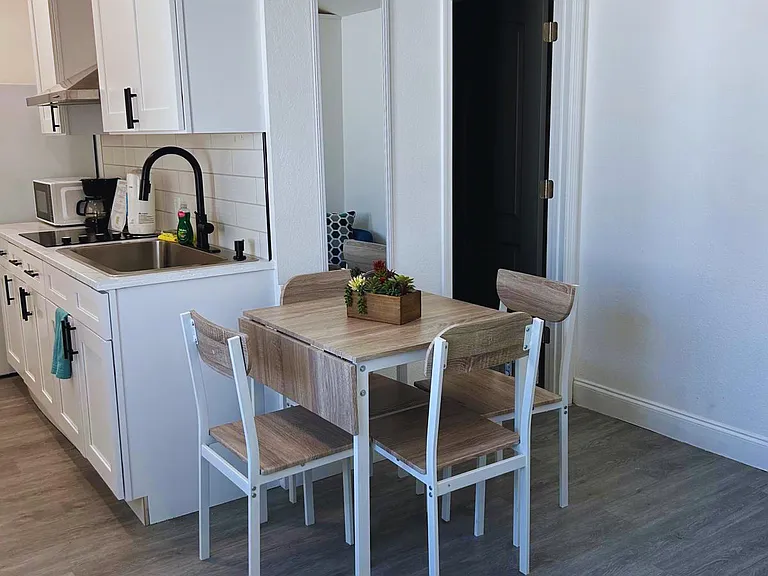 Cozy kitchen equipped with fridge and essential amenities.