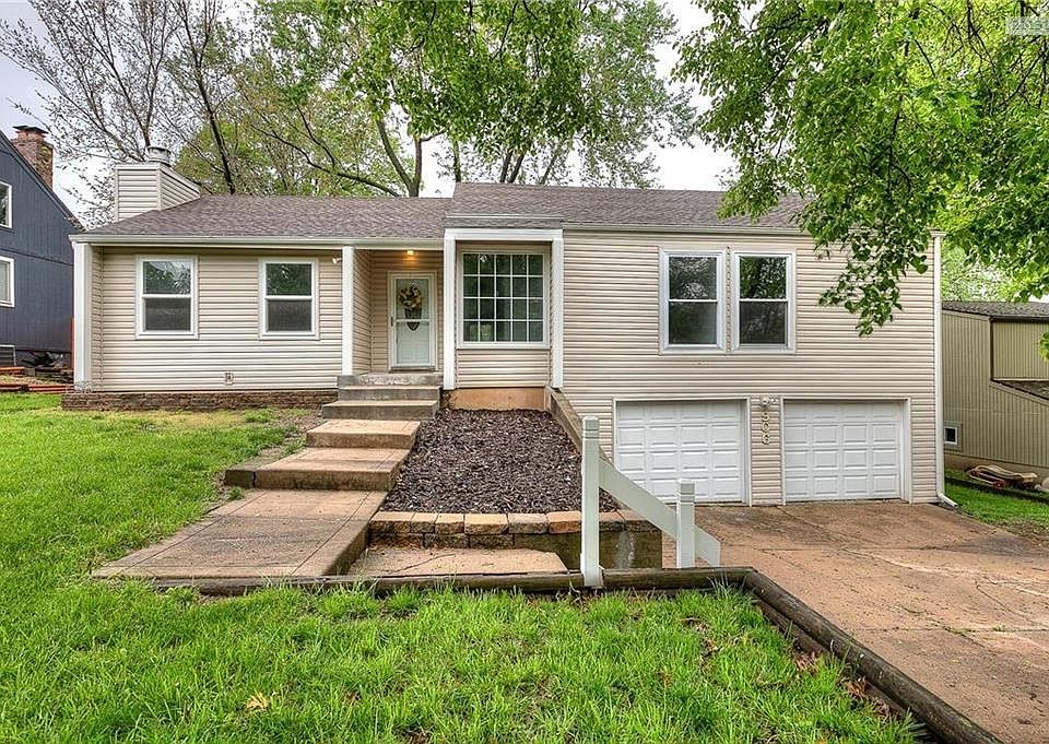 Front of the home. New siding, windows, garage doors and front door.