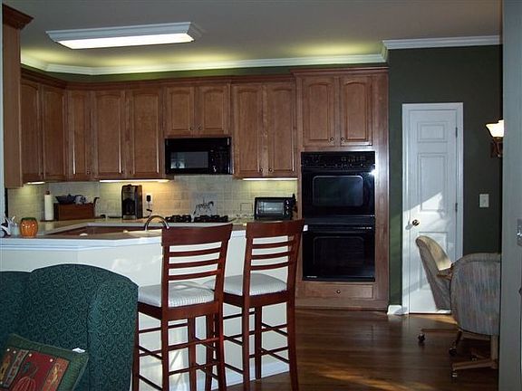 Maple cabinetry, solid surface counter tops