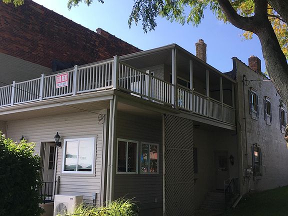 Upstairs apartment & deck at rear of building taken from park next door