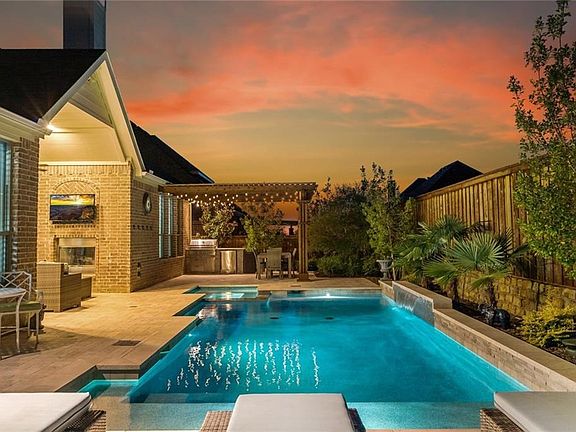 Stunning outdoor oasis complete with pool, spa, outdoor fireplace and covered patio and separate kitchen area also.