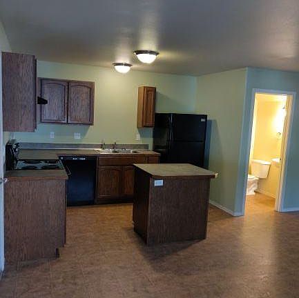 Kitchen with half bathroom left of photo.