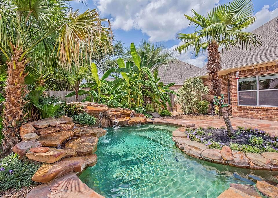 Enjoy this tropical retreat year round... it's Texas after all... and it's heated for our cooler months! Do you spy the frog on the palm tree? And the waterfall grotto?