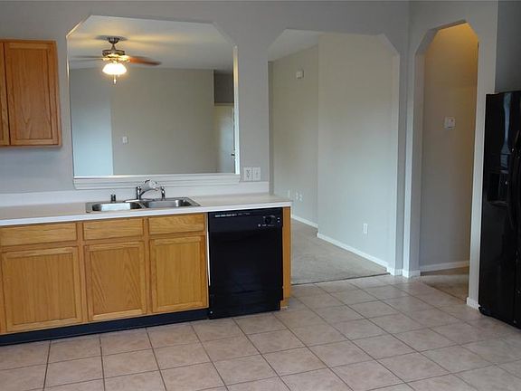 The refrigerator will be included with this home. The master bedroom is through the hall to the right and the secondary rooms are behind the family room toward the front of the house. This is a split floorplan which is nice for families.