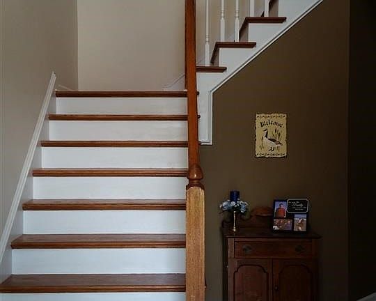 Foyer opens up to a beautiful stairwell.  Off to the left is the entrance into the living room area - owner currently using this area as game room/exercise area.