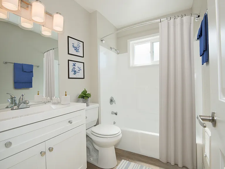 Spacious bathroom with white cabinets and soaking tub