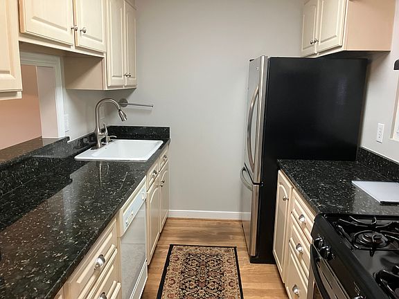 Kitchen has granite countertops and includes gas oven, microwave, coffee maker, and dishwasher