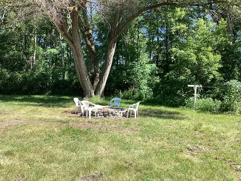 Burn pit with clothesline to the right.