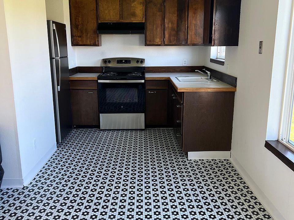 Kitchen with new refrigerator and range.