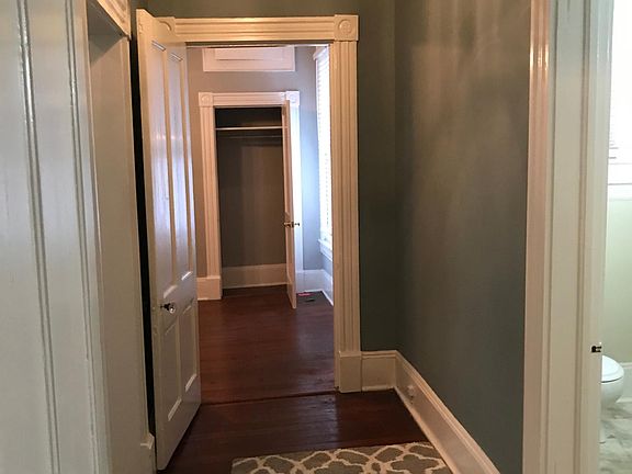 Hallway, looking into bedroom, kitchen on left, bath on right