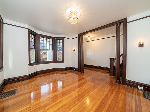 Formal Living Room with a view into the Entry Foyer. Freshly painted throughout, refinished hardwood floors with all new light fixtures!