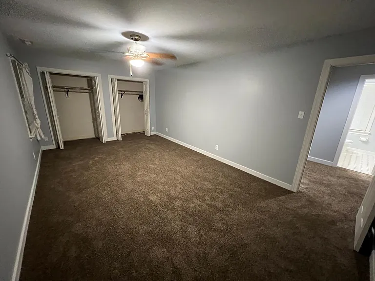 Bedroom 1 with 2 closets shown, door to hallway on the right