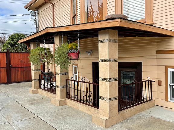 Apartment entrance is located on the side of the main house, through the back yard gate (red door located on the left side)