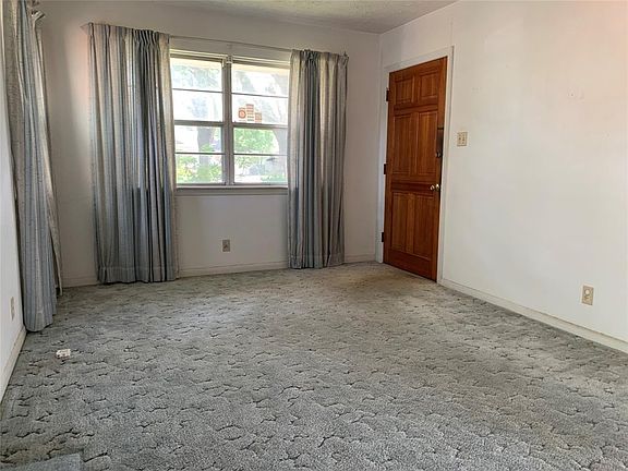View of living area. Hardwood floors under carpet.
