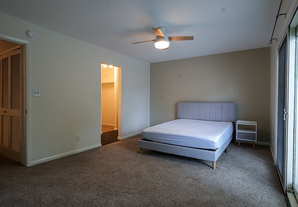 Oversized, furnished master bedroom. Balcony to right, ensuite bath to the left.