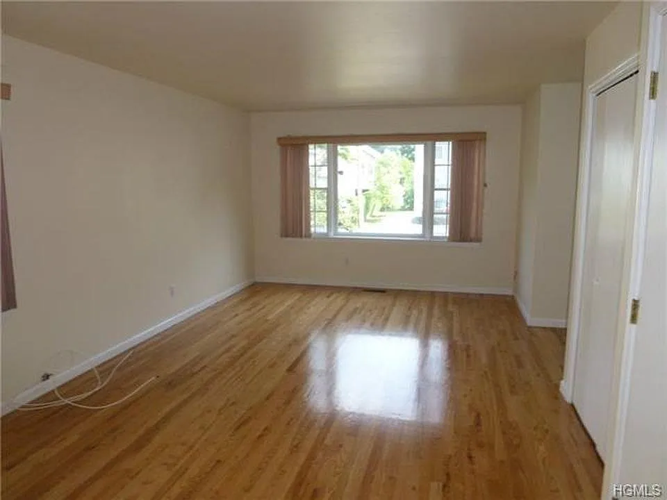 Living room with space for a dining set. There is also a large closet on the right.