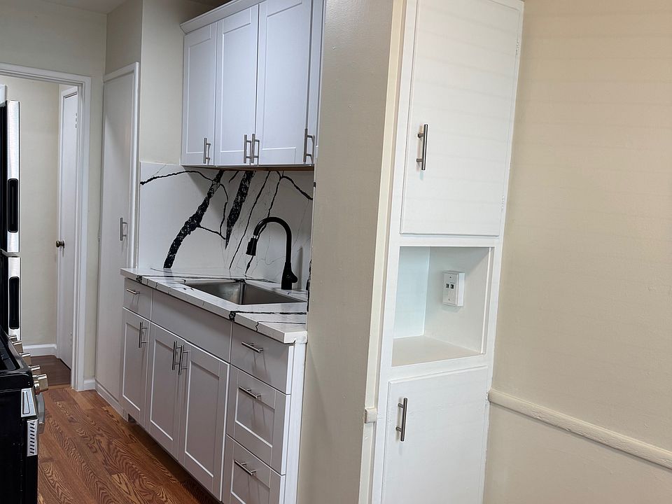Kitchen from breakfast nook. New: vinyl floor, kitchen sink, countertop and cabinets.